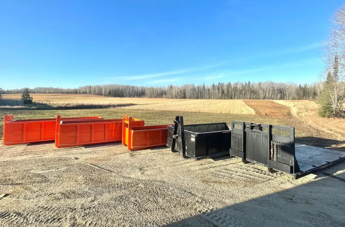 Row of Northern Bin Rentals roll-off bins ready to drop off